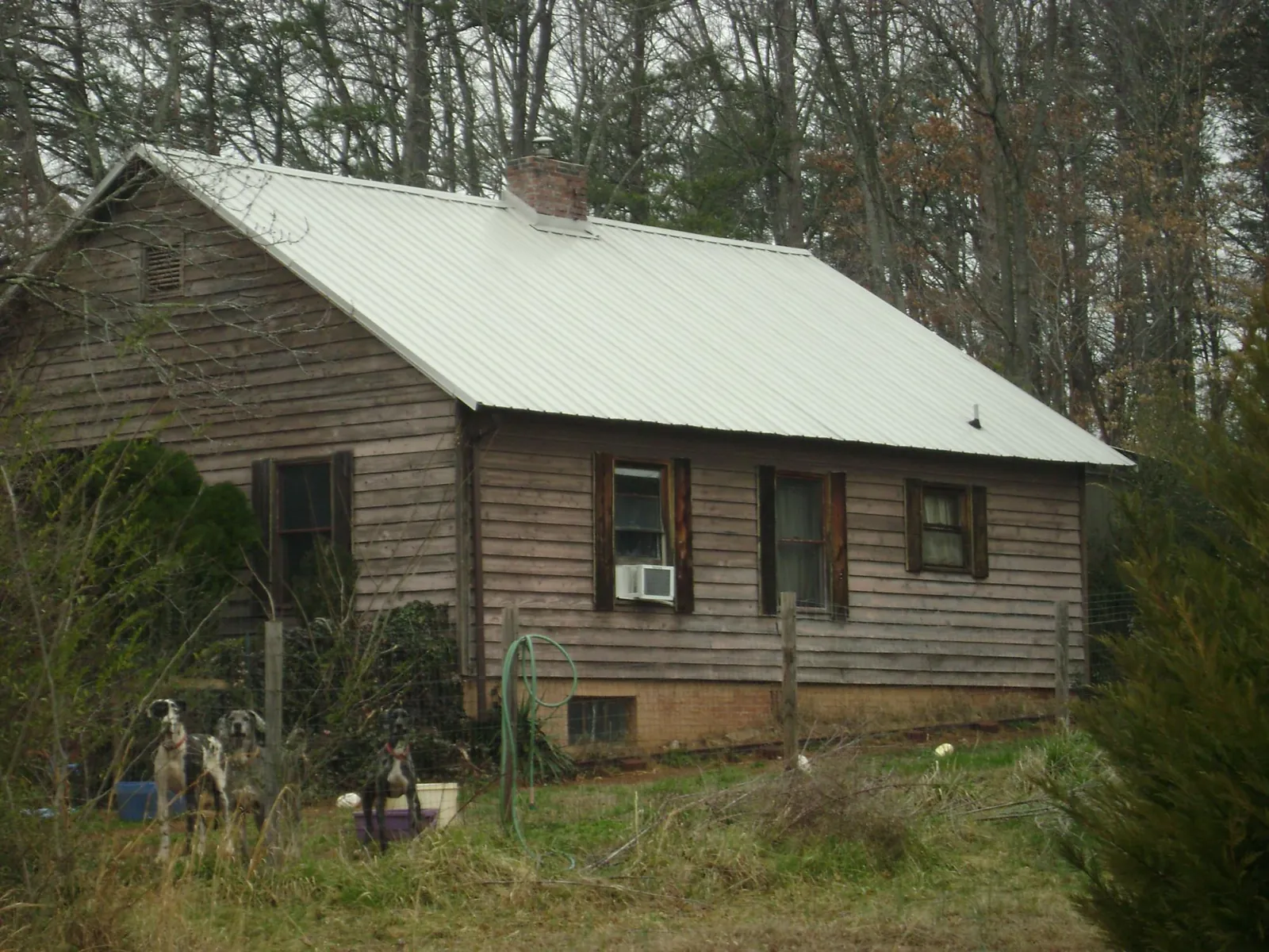 White metal roof on an old wood sided farmhouse, from a Metal Roof Installation job in New Milford